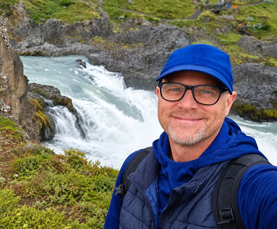 Jonathan Wiseman beside a waterfall
